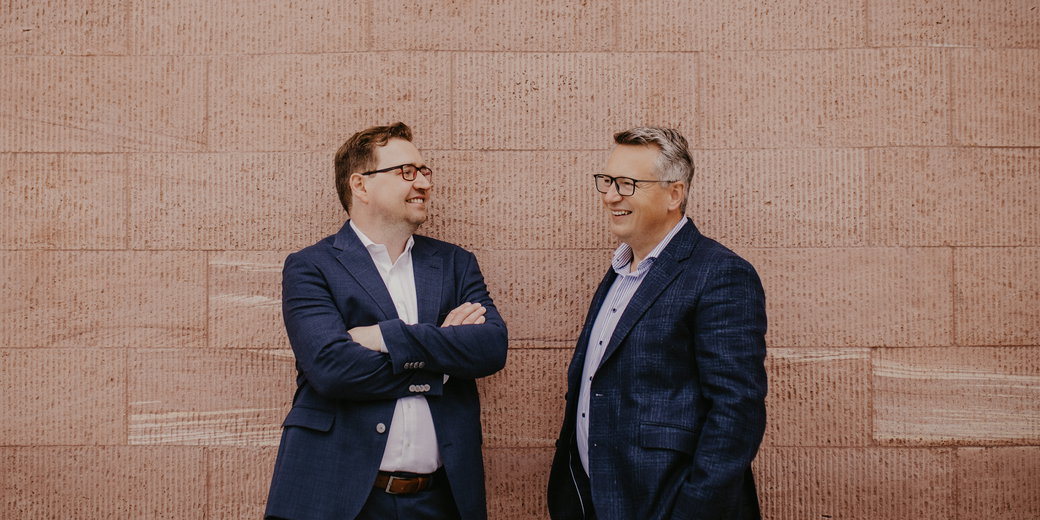 Sebastian Fastner und Sebastian Werner im Gespräch vor einer Sandsteinwand